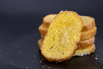 Crisp sliced butter toast on black plate