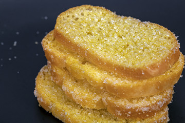 Crisp sliced butter toast on black plate