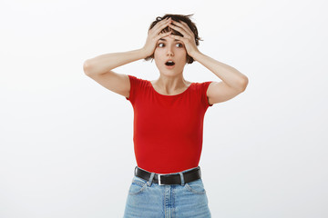Wait what. Shocked stunned intense gasping woman grab head look aside drop jaw astonished...