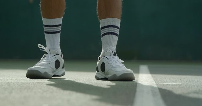 Close up shot of a tennis player serving.