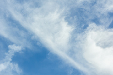 Daytime skies with colorful moon and light cloud for use as a background.