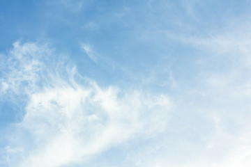 Daytime skies with colorful moon and light cloud for use as a background.