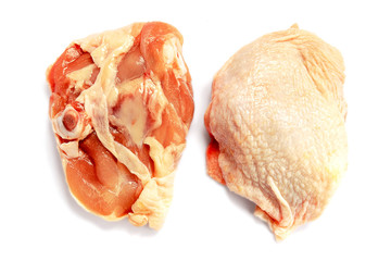 Raw chicken thigh isolated on white background with shadow. Fresh raw chicken thigh for cooking. Raw chicken thigh, isolate, close-up. View from above.