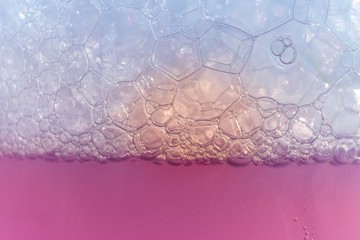 Closeup shot of a pink liquid substance with bubbles