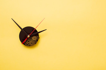 Clock hands on yellow background. Minimal time concept