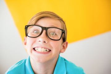 Teenager kid boy squints in myopia correction glasses