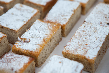 Homemade apple cake, traybake, slices on olive wood background, closeup, selective focus.