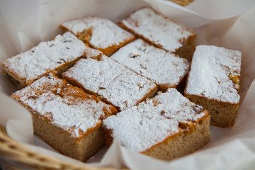 Homemade apple cake, traybake, slices on olive wood background, closeup, selective focus.