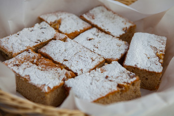 Homemade apple cake, traybake, slices on olive wood background, closeup, selective focus.