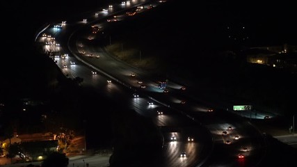 Early morning commuter headlights on route 118 freeway in Simi Valley moving towards Los Angeles California.