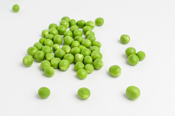 Fresh organic green peas isolated on white randomly displayed, side view, with space for text