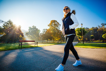 Middle-aged woman walking in city park