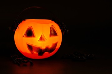 Halloween pumpkin with scary spiders in the dark.