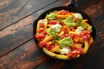 Loaded potato nachos with melted cheddar cheese, sour cream, tomato salsa, chilli, guacamole and beer