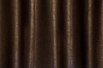 Fototapeta premium Brown curtain texture background in dark light.
