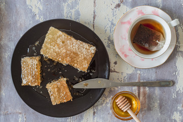 Top view of cup of red tea with honeycomb and honey, top view, flat lay, can be for Rosh Hashana concept