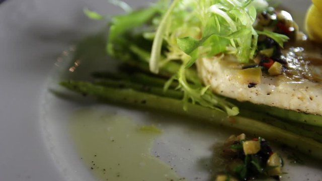 Close-up of grilled pike perch fillet with asparagus and lemon