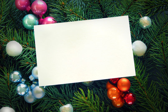 Fir branches with toys close-up. White background for greetings and invitations. Textua and background for New Year and Christmas.