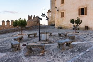 Cloister with benches and well in the Sanctuary of Sant Salvador Arta Mallorca