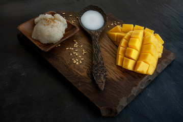 Fresh ripe mango (Barracuda mango) and sticky rice with coconut milk, authentic Thai dessert,...