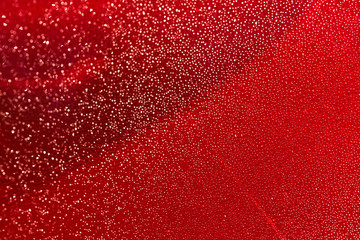 Drops of dew on the red lamp of the car. Beautiful background with water on the glass