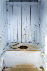 interior of an old wooden outhouse