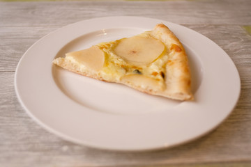 Delicious pizza with Round Pear Slices, Roquefort Blue Cheese served at Italian Restaurant with Plate. Traditional Food