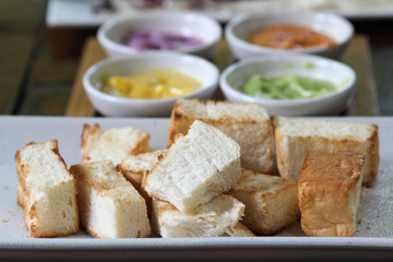 Bread toast and Thai custard on white plate.