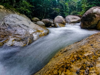 Naklejka na ściany i meble Selected focus view of crystal clear white water rapid in tropical forest in Malaysia 