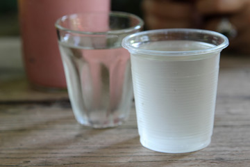 Cool drinking water in a clear plastic glass.