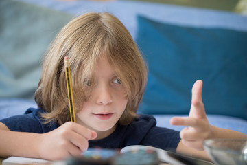 Young boy counting numbers with his hand