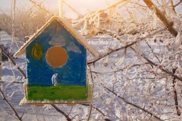 Feeder for birds in the form of a house. Winter morning.