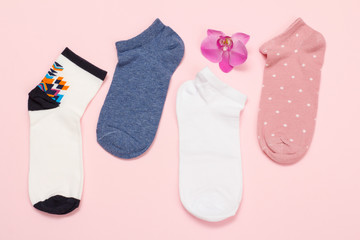 Women socks on pink background. Top view.