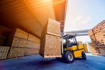 Forklift loader load lumber into a dry kiln. Wood drying in containers.