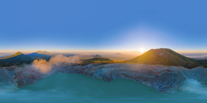 360 panorama by 180 degrees angle seamless panorama view of aerial view of Kawah Ijen volcano with turquoise sulfur water lake at sunrise. Panoramic view at East Java, Indonesia. Natural landscape.