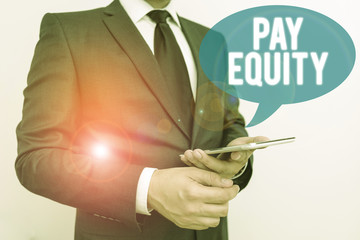 Writing note showing Pay Equity. Business concept for eliminating sex and race discrimination in...