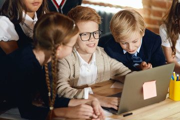 ginger boy in glasses and his team thinking about prosperous business plan, shraing ideas, close up photo