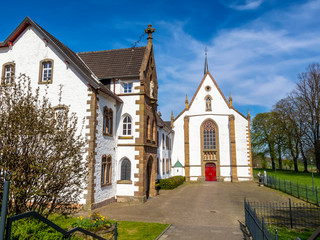 Fototapeta premium Mariawald Trappist Abbey with church above the village of Heimbach, District of Dueren, North Rhine-Westphalia, Germany, the only extant men's Trappist monastery in Germany