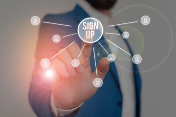 Writing note showing Sign Up. Business concept for use your information to register in website team college or blog Male wear formal work suit presenting presentation smart device