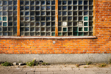 Red brick wall with glass block window