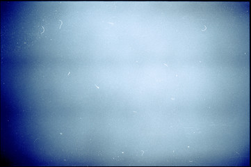 Noisy blue film frame with scratches, dust and grain