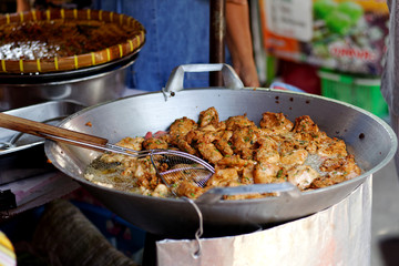 Frying Fish Cakes (Tod Man Pla) in big pan.Street food in local market