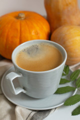 cup of black coffee and pumpkins