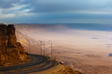 The road descending into the crater on the background of mountains