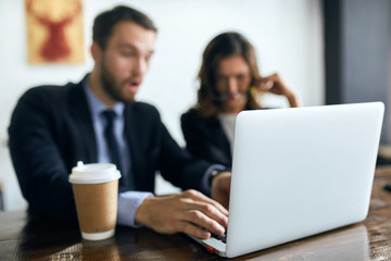 close up photo. focus on laptop. blurred background, business people being shocked to find out that...