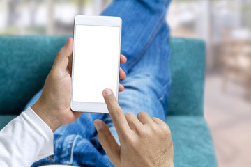 Online order and express delivery service food shopping concept on touch screen which hand's man holding smart phone lying on sofa at home background. Lifestyle in city.