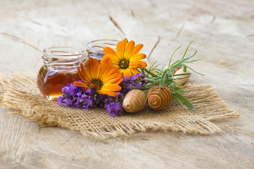 honey and flowers on wooden background