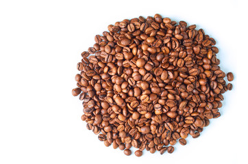 A mound of roasted coffee beans isolated on a white background.