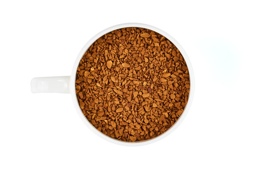 White cupa with instant coffee isolated on white background. Top view.