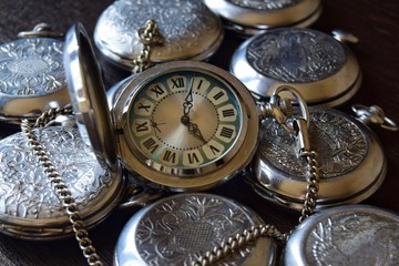 Vintage pocket watch with a red dial in retro style close up. Selective focus. Photo background